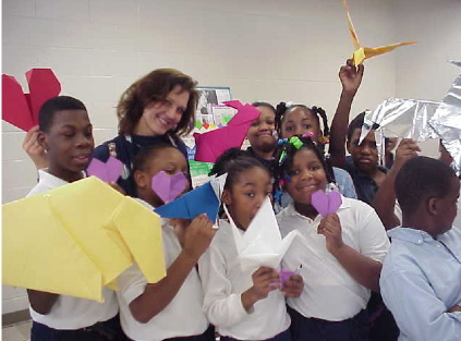 Kids holding origami with Storigami author Christine Kallevig